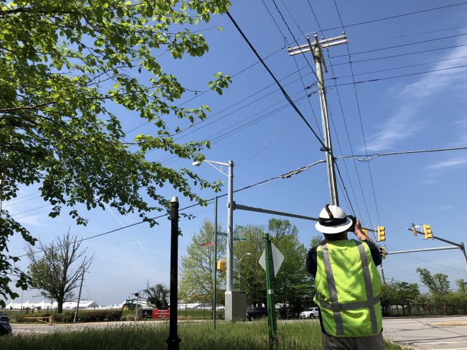 BGE customer reliability support employee inspecting overhead electric equipment