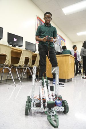 Student shows off his robot