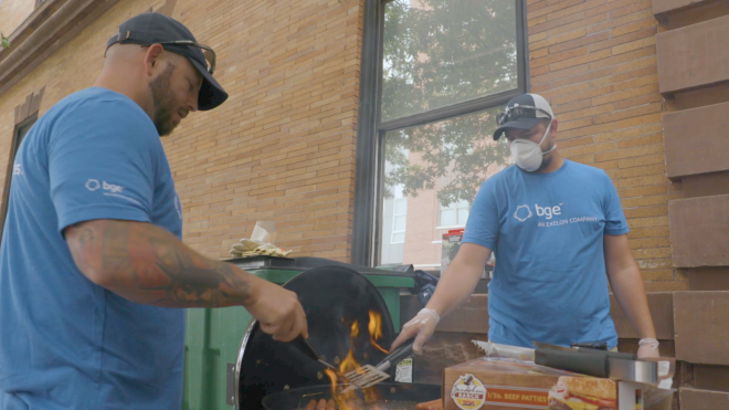 Two BGE volunteers cooking