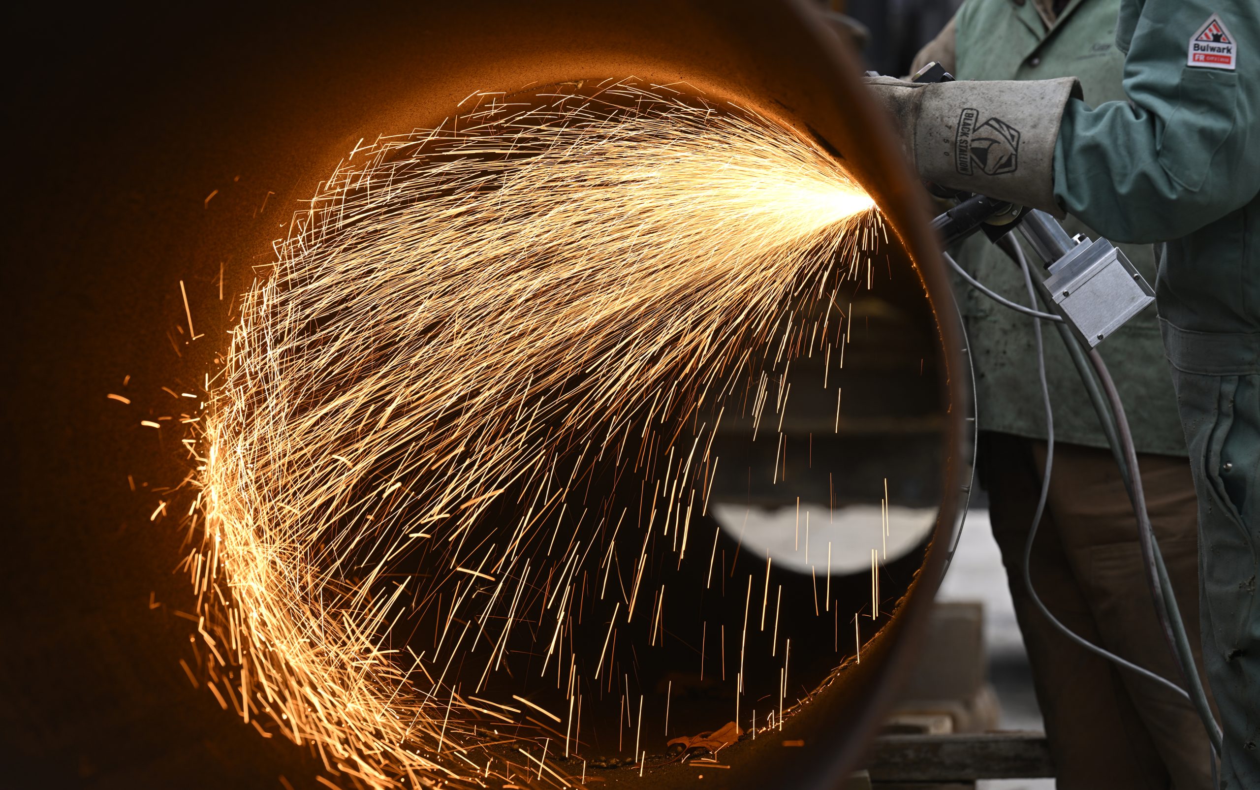Welder working on infrastructure pipe