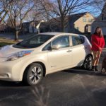 ComEd employee standing next to her electric vehicle