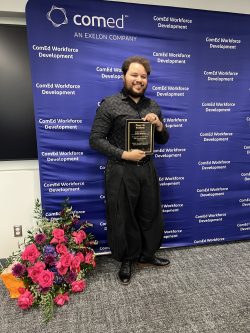 Jordan Wildman receives his Power Up Academy graduation plaque
