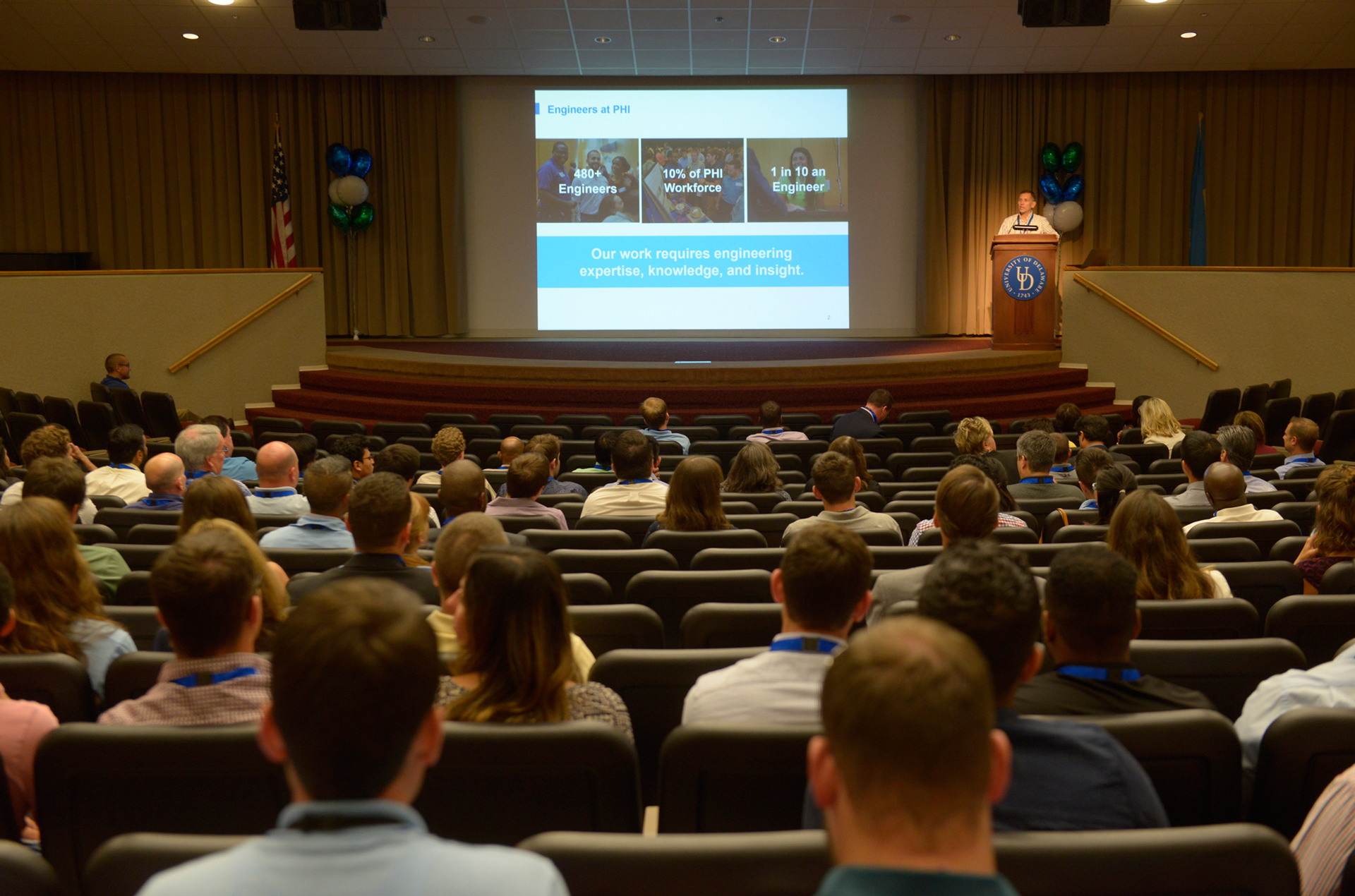 Pepco Holdings CEO stands on stage in front of engineer fair attendees