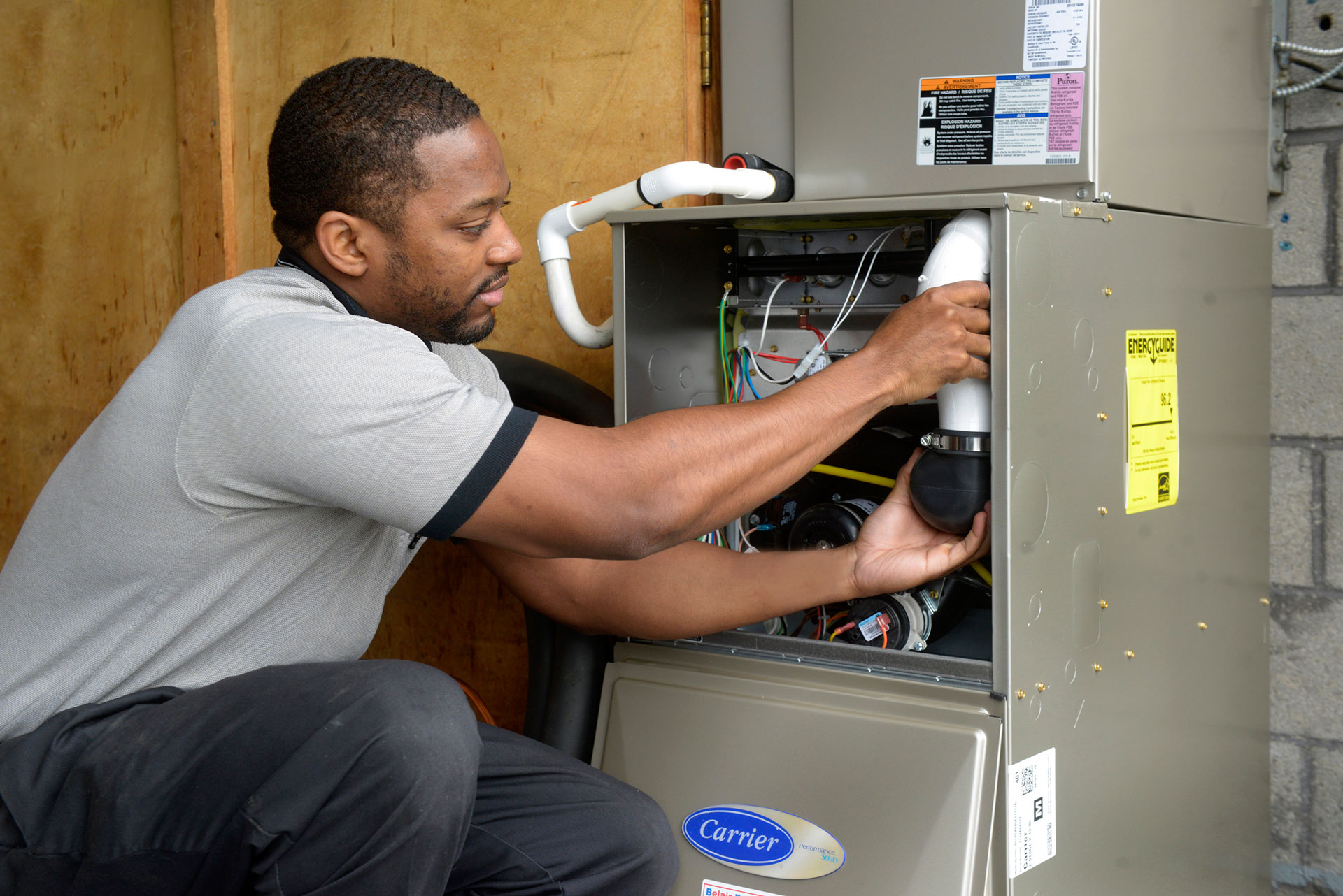 employee fixing air conditioning unit