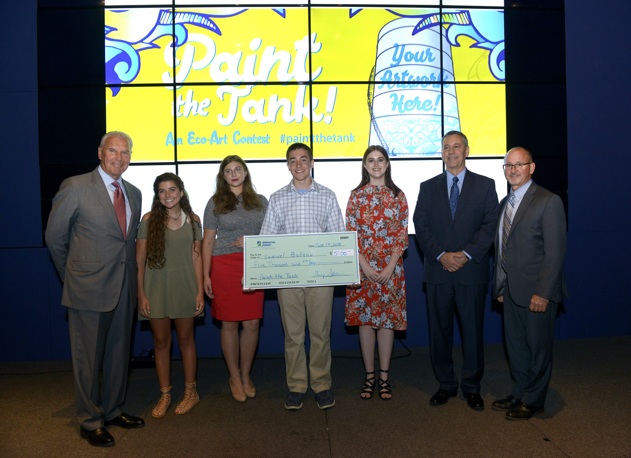 contest winners holding check